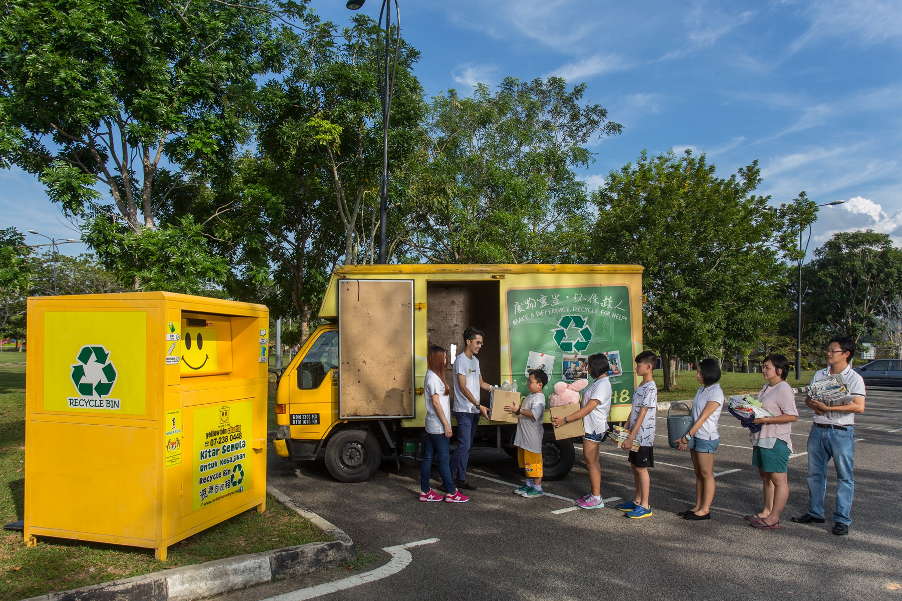 Residents dropping off old clothes at a Yellow Bin textile recycling point in Johor Bahru